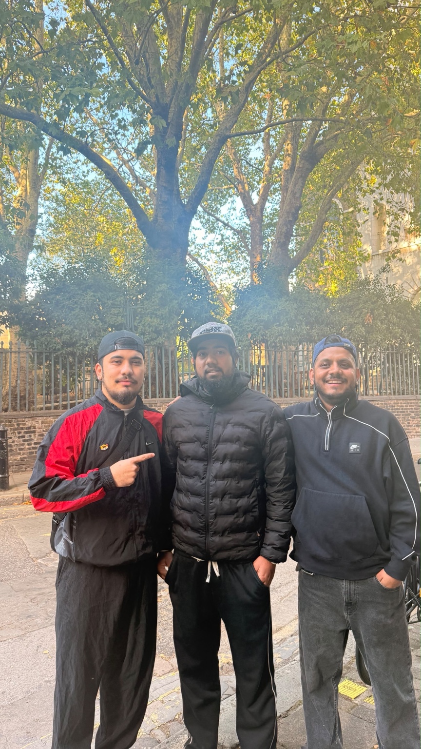 Bibek Thapa, centre, with two community members after being found safe